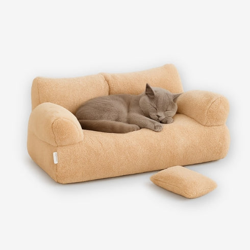 Canapé pour chat beige avec coussin amovible, en tissu doux, présenté en vue studio.