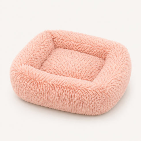 Coussin apaisant rectangulaire pour chat en tissu ultra moelleux rose, présenté sur fond neutre en studio.
