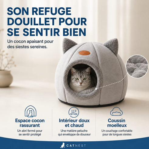 Chat installé dans une grotte pour chat grise avec intérieur en peluche douce et coussin moelleux, formant un cocon chaud et rassurant pour ses siestes.