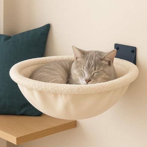 Lit mural pour chat en tissu blanc effet peluche, fixé au mur, avec un chat gris endormi dans un couchage arrondi et confortable.