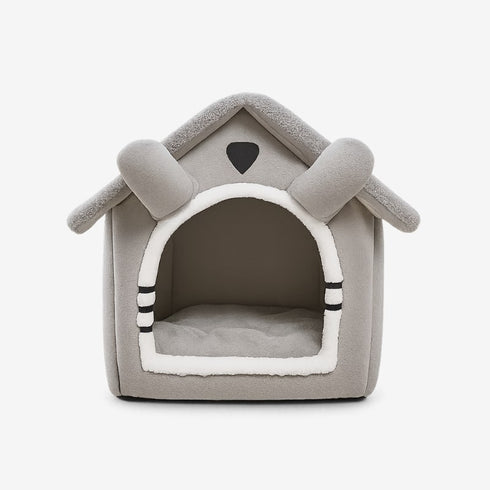 Maison à chat grise en tissu, vue de face sur fond blanc, avec coussin intégré.