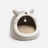 Maison douillette grise pour chat avec oreilles décoratives, pompon suspendu et coussin intérieur confortable sur fond clair en photo produit
