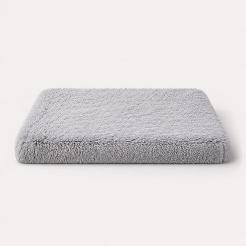 Matelas pour chat gris en peluche douce avec rembourrage épais, couchage confortable et design sur fond studio épuré.