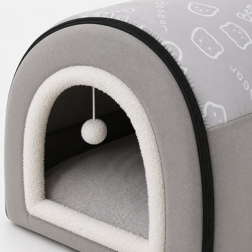 Détail d’une petite niche pour chat grise avec bordure en peluche blanche, coussin moelleux et fermeture zippée pratique.