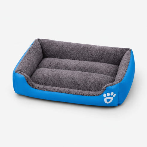 Panier chauffant pour chat bleu et gris avec rebords rembourrés et surface douce, idéal pour offrir un couchage chaud et confortable.