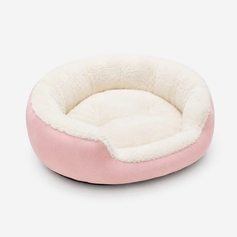 Panier rond pour chat rose clair en peluche ultra douce avec coussin moelleux et rebords épais pour un repos confortable.